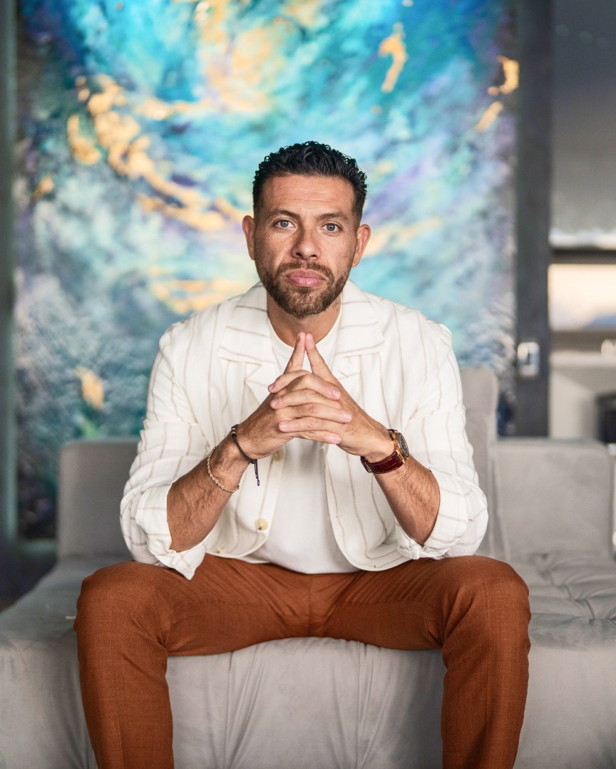 Gerard Adams seated in reflection