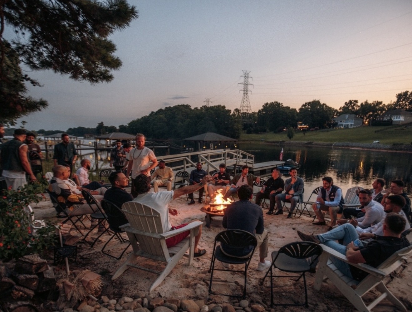 LCL members connecting around a lakeside fire at sunset